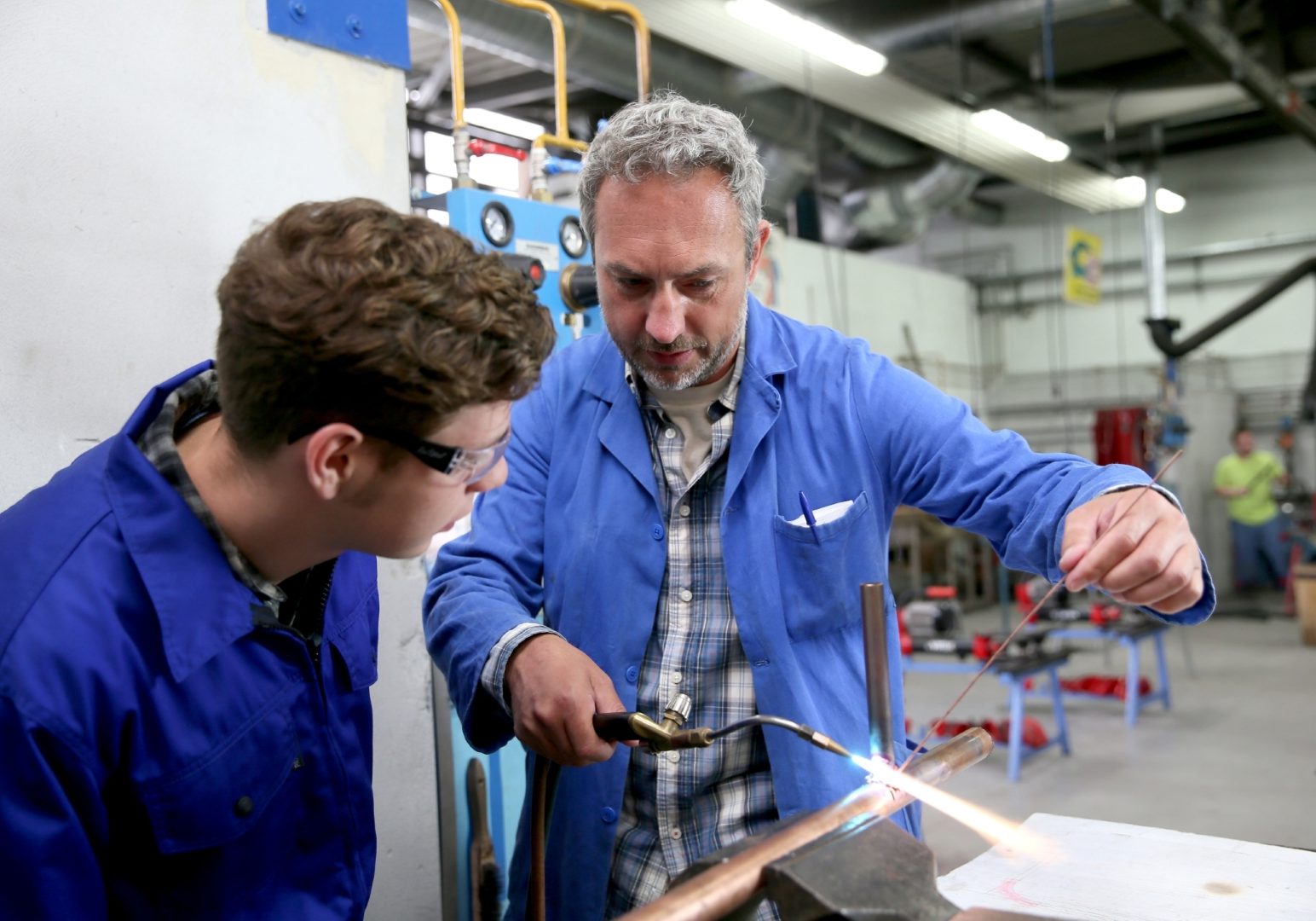 Teacher with student in metallurgy workshop